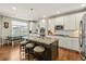Bright and airy kitchen featuring a large island, stainless steel appliances, and an adjacent dining area at 31353 E 163Rd Ave, Hudson, CO 80642