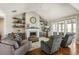 Bright living room featuring a fireplace, ceiling fan, and sliding glass doors at 31353 E 163Rd Ave, Hudson, CO 80642