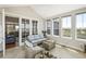 Bright sunroom with wicker seating, large windows, and tile floors at 31353 E 163Rd Ave, Hudson, CO 80642