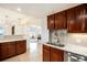 Cozy kitchen featuring granite countertops and wood cabinetry at 1029 E 8Th Ave # 1302, Denver, CO 80218