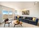The cozy living room boasts balcony access, a plush couch, and modern track lighting at 1029 E 8Th Ave # 1302, Denver, CO 80218