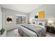 Calm bedroom with a large window, stylish headboard, soft gray tones, and minimalist decor at 8755 W Cornell Ave # 14-5, Lakewood, CO 80227