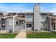 Charming gray townhome featuring tidy landscaping, multiple windows, and a neatly paved walkway to the front door at 8755 W Cornell Ave # 14-5, Lakewood, CO 80227