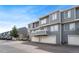 Townhome with grey siding, balcony, and attached garages at 8755 W Cornell Ave # 14-5, Lakewood, CO 80227