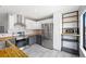 Modern kitchen featuring white cabinets, stainless steel appliances, open shelving and butcher block countertops at 8755 W Cornell Ave # 14-5, Lakewood, CO 80227