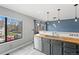 Bright kitchen featuring stainless steel appliances, butcher block countertops, sink with a view and modern lighting at 8755 W Cornell Ave # 14-5, Lakewood, CO 80227