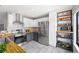 Well-lit kitchen featuring stainless steel appliances, wood countertops, white subway tile, and ample storage shelves at 8755 W Cornell Ave # 14-5, Lakewood, CO 80227
