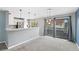 Open living space with kitchen access, a view through sliding doors, and ample sunlight, perfect for entertaining at 8755 W Cornell Ave # 14-5, Lakewood, CO 80227
