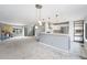 Open-concept living room with a fireplace, modern kitchen, pendant lighting, and large windows offer a welcoming space at 8755 W Cornell Ave # 14-5, Lakewood, CO 80227