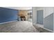 Inviting living area featuring a cozy fireplace with stone surround and a front door leading to the outside at 8755 W Cornell Ave # 14-5, Lakewood, CO 80227