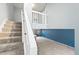 Inviting staircase leading to upper level with open railing detail and an accent wall at 8755 W Cornell Ave # 14-5, Lakewood, CO 80227