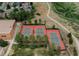 Aerial view showcases three tennis courts in a community surrounded by trees at 9687 Timbervale Ct, Highlands Ranch, CO 80129