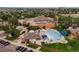 Aerial view showcases a community center with a pool, waterslides, and surrounding greenery at 9687 Timbervale Ct, Highlands Ranch, CO 80129