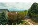 Serene backyard view with mature trees, landscaping, and mountain views at 9687 Timbervale Ct, Highlands Ranch, CO 80129