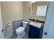 Charming powder room with navy blue vanity, decorative tile, and designer accents at 9687 Timbervale Ct, Highlands Ranch, CO 80129