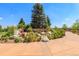Scenic community entrance with stone signage, lush landscaping, and walking paths at 9687 Timbervale Ct, Highlands Ranch, CO 80129