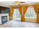 Cozy living room featuring a fireplace, wood floors and lots of natural light at 9687 Timbervale Ct, Highlands Ranch, CO 80129