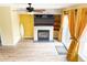 Cozy living room featuring a fireplace, wood floors and lots of natural light at 9687 Timbervale Ct, Highlands Ranch, CO 80129