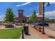 Vibrant shopping center with a clock tower, retail stores, and well-maintained sidewalks at 9687 Timbervale Ct, Highlands Ranch, CO 80129