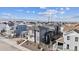 Aerial view of a new neighborhood with mountain backdrop and solar panels at 8403 Rush Creek Ave, Littleton, CO 80125