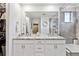 A bathroom with double sinks, granite counters, and a glass shower showcasing modern design and functionality at 8403 Rush Creek Ave, Littleton, CO 80125