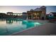 Community pool with lounge seating and a clubhouse in the background at 8403 Rush Creek Ave, Littleton, CO 80125
