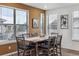 The dining room features a wooden table with seating for six, with lots of natural light from the windows at 8403 Rush Creek Ave, Littleton, CO 80125