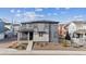 Modern two-story home featuring a stylish mix of gray siding and stone accents in a cozy community at 8403 Rush Creek Ave, Littleton, CO 80125