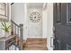 Elegant foyer showcasing wood floors, staircase, stylish decor, and a decorative accent wall, creating a welcoming entrance at 8403 Rush Creek Ave, Littleton, CO 80125