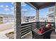 Inviting front porch with stone columns and comfortable wicker seating, offering a relaxing outdoor space at 8403 Rush Creek Ave, Littleton, CO 80125