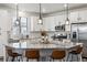 Well-lit kitchen featuring white cabinetry, granite countertops, stainless steel appliances, and a large center island with seating at 8403 Rush Creek Ave, Littleton, CO 80125