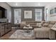 Comfortable living room with a plush sectional sofa, stylish decor, and a relaxing atmosphere with natural light at 8403 Rush Creek Ave, Littleton, CO 80125