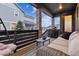 Inviting covered patio with comfortable seating, stone columns, and relaxing ambiance at 8403 Rush Creek Ave, Littleton, CO 80125