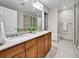 Well-lit bathroom with double vanity, granite countertops, and tiled floor at 2200 S University Blvd # 105, Denver, CO 80210