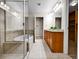Elegant bathroom featuring a glass shower, soaking tub, and double vanity sink at 2200 S University Blvd # 105, Denver, CO 80210