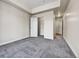 Spacious bedroom featuring plush carpet, closet and entrance to the ensuite bathroom at 2200 S University Blvd # 105, Denver, CO 80210