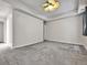 Spacious bedroom with neutral paint, plush gray carpet and modern ceiling fan at 2200 S University Blvd # 105, Denver, CO 80210