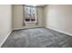 Empty bedroom with a large window, neutral paint, and gray carpet at 2200 S University Blvd # 105, Denver, CO 80210