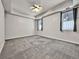 Bright bedroom with gray carpet, contemporary ceiling fan, and updated windows at 2200 S University Blvd # 105, Denver, CO 80210