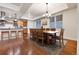Open dining area with wood floors, a chandelier, and a large table for gatherings at 2200 S University Blvd # 105, Denver, CO 80210