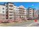 Modern apartment building exterior featuring balconies, brick accents, and a well-maintained landscape at 2200 S University Blvd # 105, Denver, CO 80210
