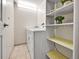 Efficient laundry room with washer, dryer, and shelving for storage at 2200 S University Blvd # 105, Denver, CO 80210