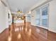 Spacious living room featuring hardwood floors and a view into the kitchen at 2200 S University Blvd # 105, Denver, CO 80210