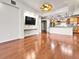 Open living space with a modern kitchen view, hardwood floors, and neutral decor at 2200 S University Blvd # 105, Denver, CO 80210