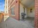 Outdoor patio area featuring a grill and a partial brick wall at 2200 S University Blvd # 105, Denver, CO 80210