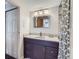 Bathroom with modern vanity, stylish mirror, and shower with patterned curtain at 1050 N Corona St # 304, Denver, CO 80218