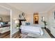 Cozy bedroom with stylish decor, soft lighting, and a view into the living area at 1050 N Corona St # 304, Denver, CO 80218