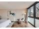 Bright bedroom features modern art, hardwood floors, and an oversized picture window at 1050 N Corona St # 304, Denver, CO 80218
