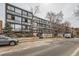 Modern apartment building with expansive windows and nearby trees at 1050 N Corona St # 304, Denver, CO 80218