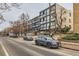 Street view of a brick apartment building with modern architecture and landscaping at 1050 N Corona St # 304, Denver, CO 80218
